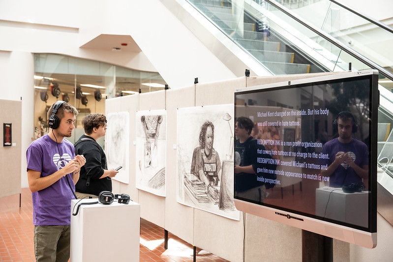 Guests view artwork on display.