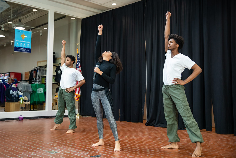 Leah Bouvier, Dmo Acheka and Marques Jackson perform song and dance.