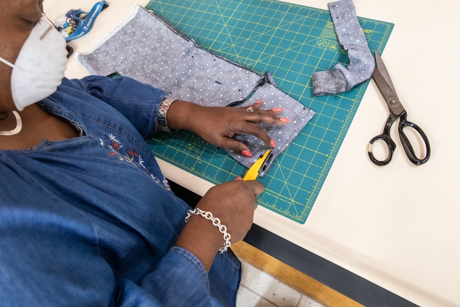 ACC Facilities support teams cut facial coverings for essential employees