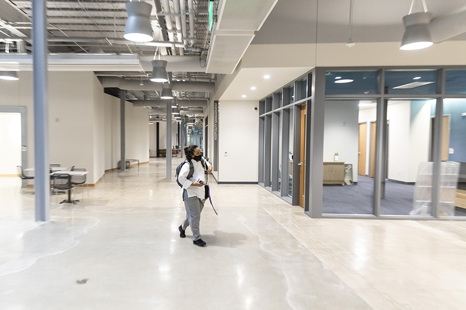 ACC Culinary Arts student Ora E. walks through Highland Campus, Building 2000 on her way to her first class of the spring 2021 semester, Meat Prep with Chef David Waggoner. 