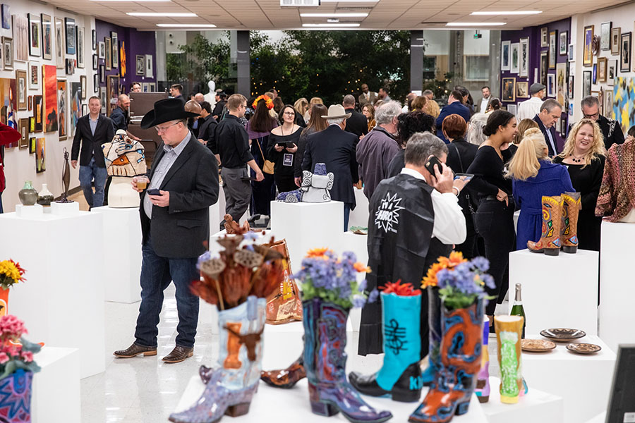 People participating in the art auction at the Boots and Bats Gala.