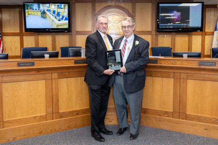 William Peck Young (right) being presented with a plaque for his retirement by ACC President/CEO Dr. Richard Rhodes 