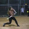 A baseball player swings at a pitch.